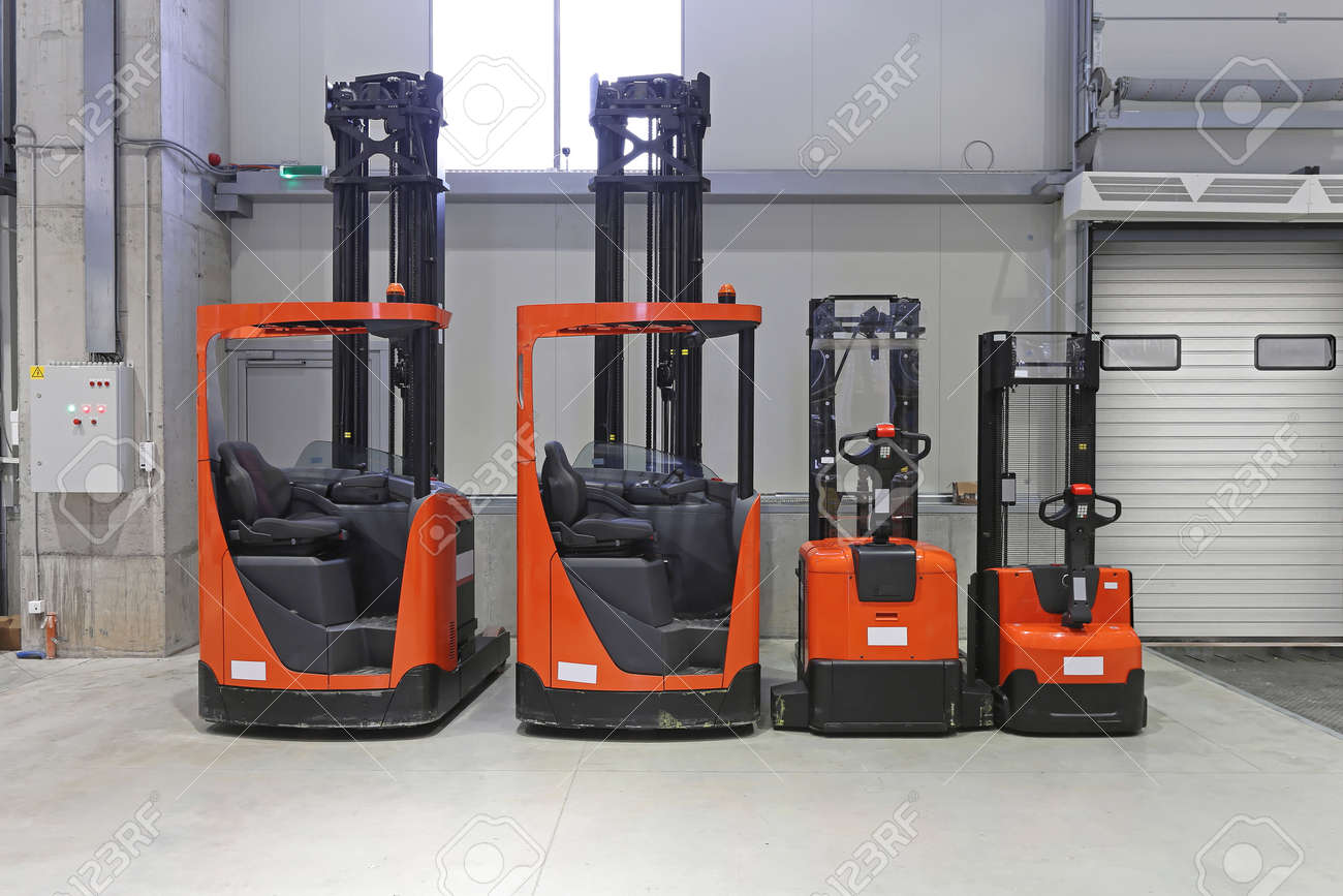 108071272-pallet-trucks-and-forklifts-in-distribution-warehouse